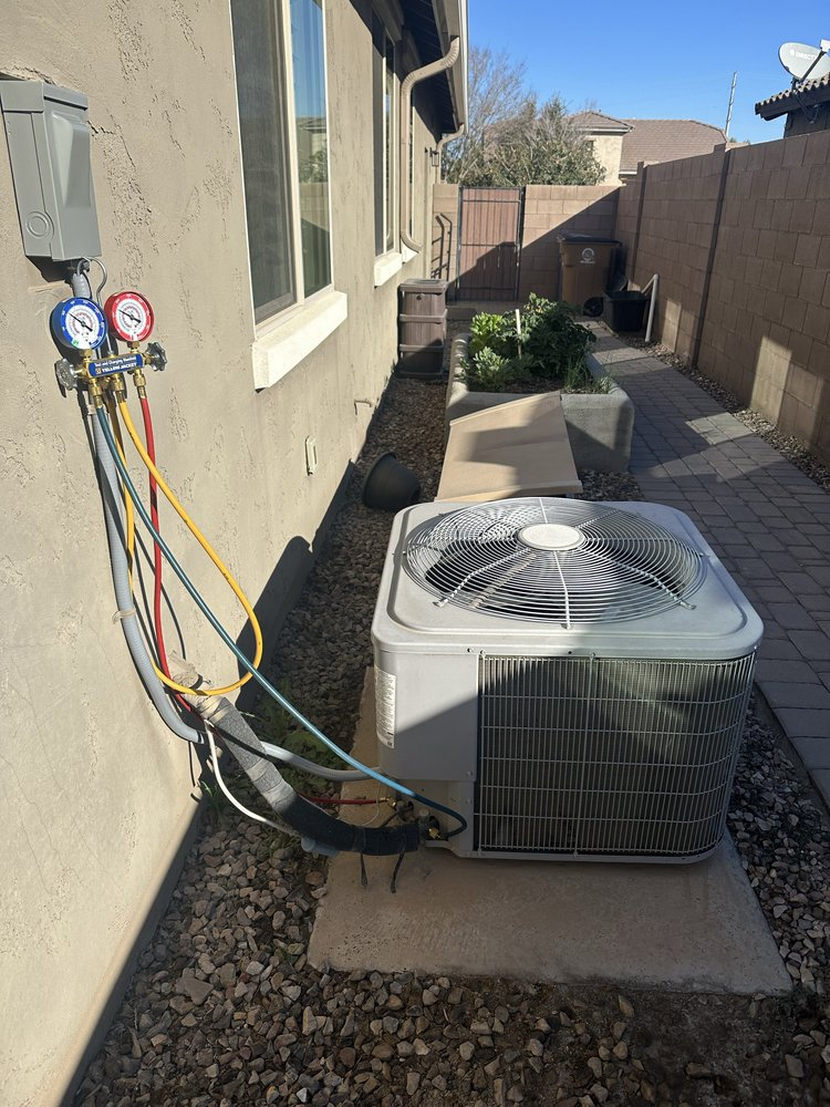 HVAC technician servicing an AC unit